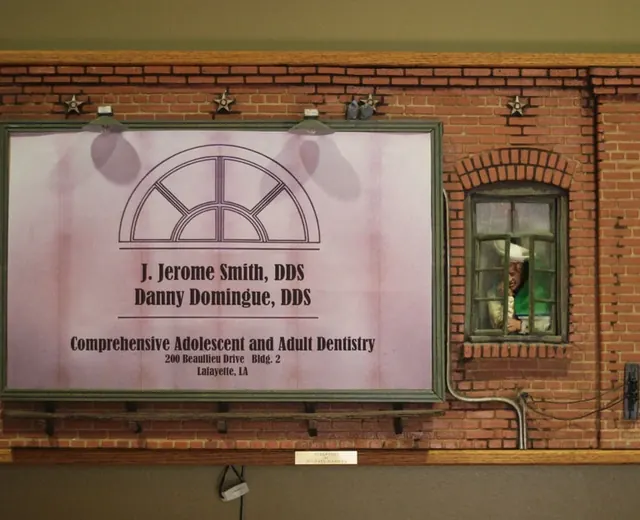 The arched-window sign for J. Jerome Smith, DDS and Danny Domingue, DDS on a brick wall at the practice.